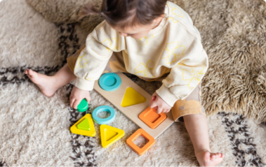 Child with the Lovevery Geo Shapes Puzzle