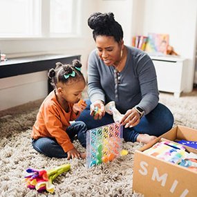 Mom and child with Lovevery toy