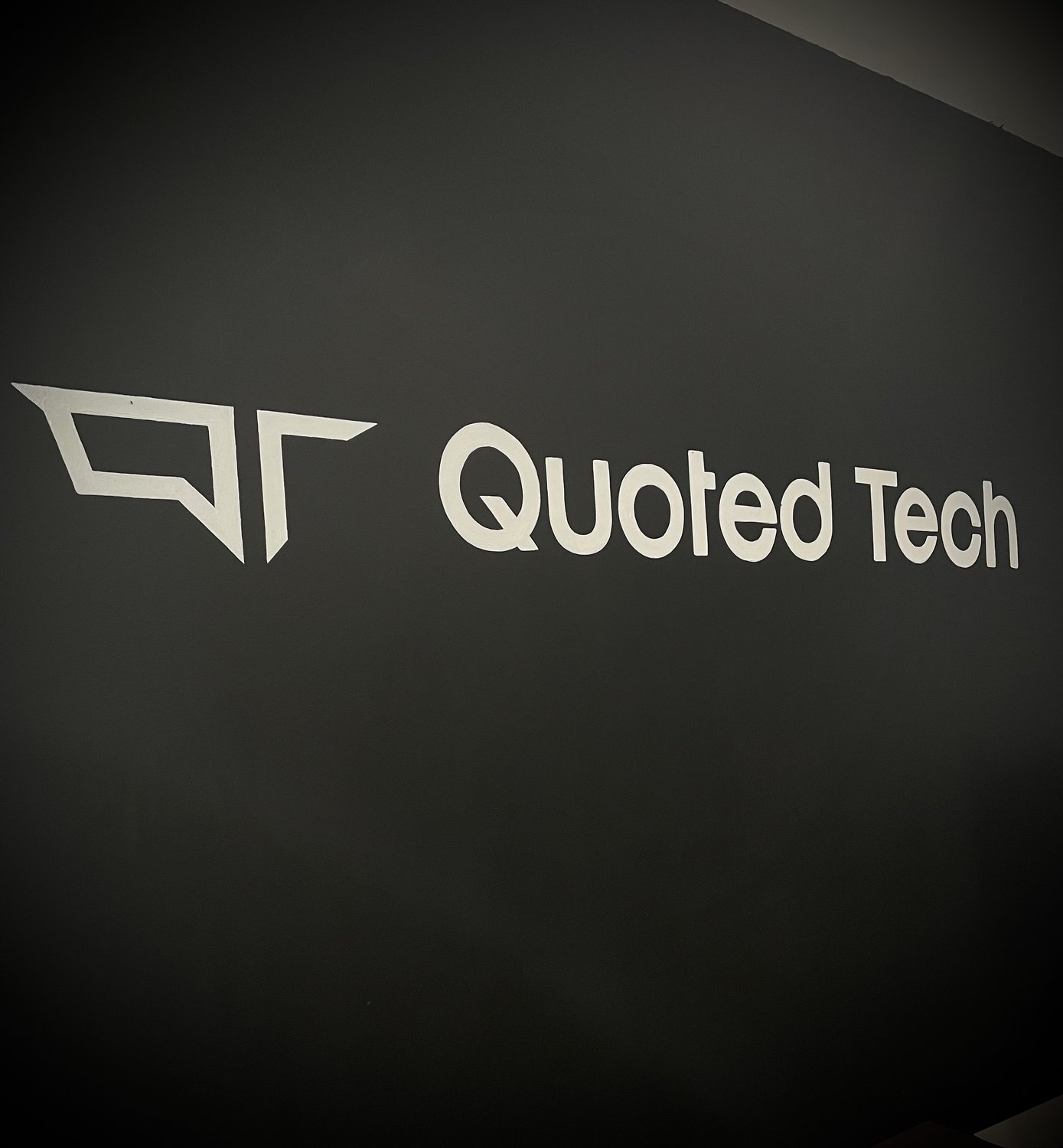 Quoted Tech Logo hand painted onto a office wall
