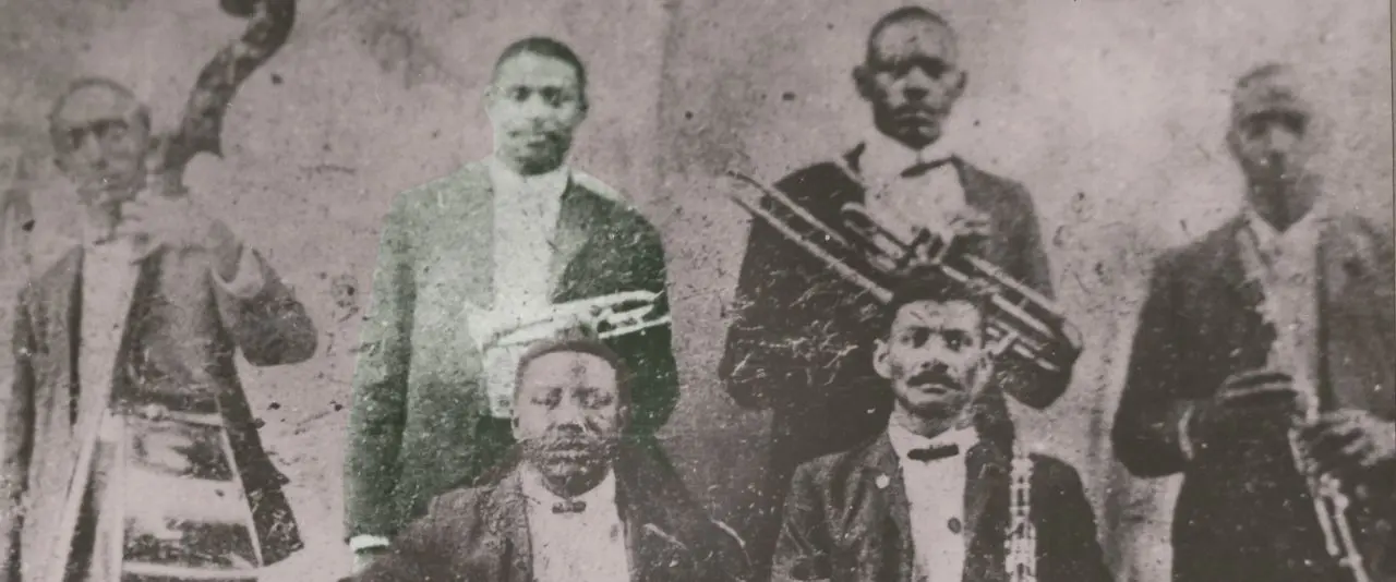 In this circa 1905 photo, Charles “Buddy” Bolden is pictured standing second from left with his band. Also pictured are Willie Warner; Willie Cornish; Jimmie Johnson; Frank Lewis and Brock Mumford. This is the only known photo of Buddy Bolden. Image courtesy of Hogan Jazz Archive, Tulane University.