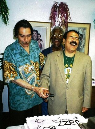 Hilton Ruiz and Dave Valentin cutting KUVO anniversary cake