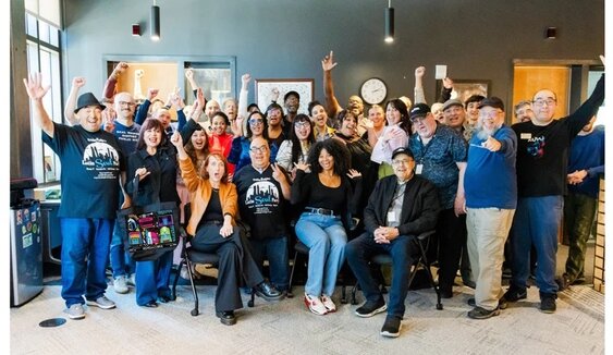 Hosts gather with staff