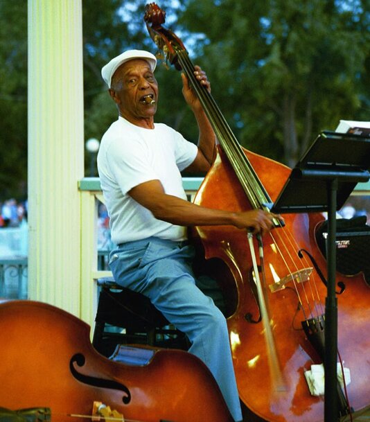 Charles Burrell playing upright bass on outdoor stage