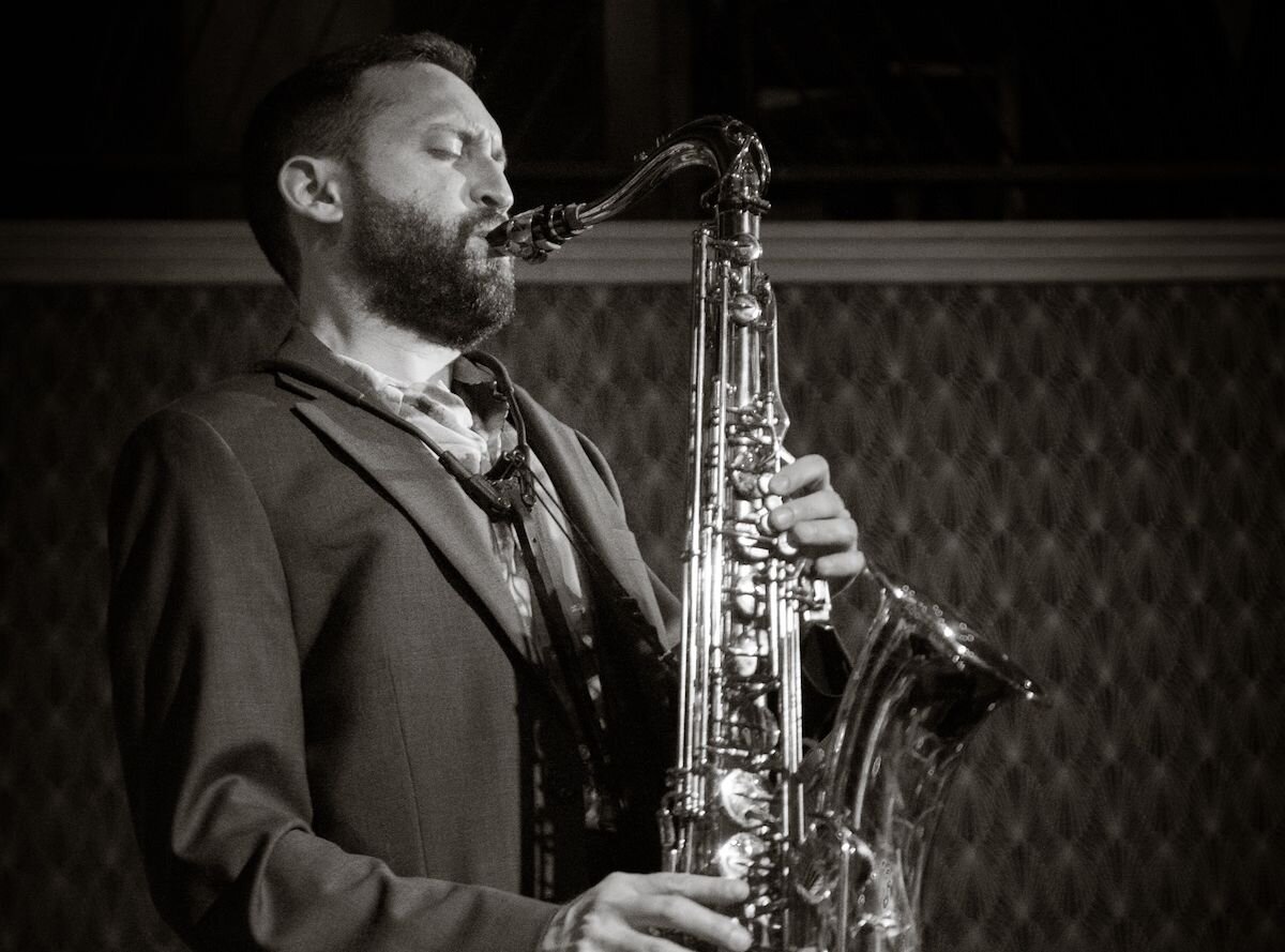 A poster for The Adam Gang Quartet event