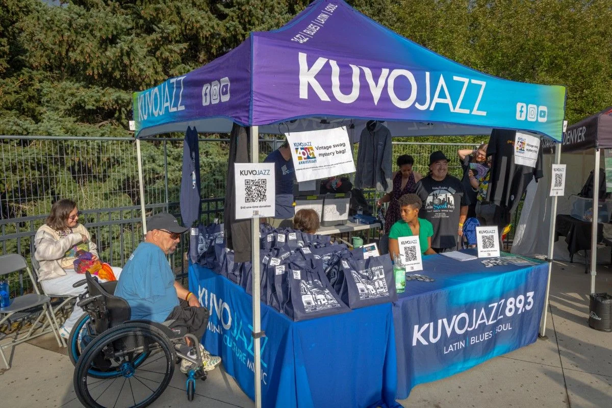 KUVO booth and volunteers