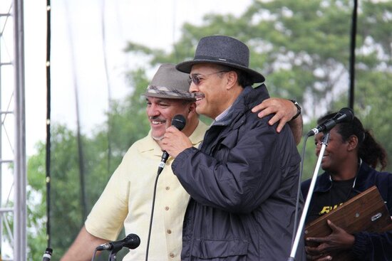 Arturo Gómez and Carlos Lando speaking on stage