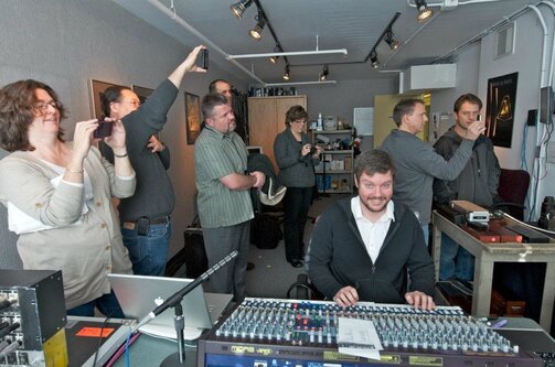 Parents taking pictures of their kids performing in studio