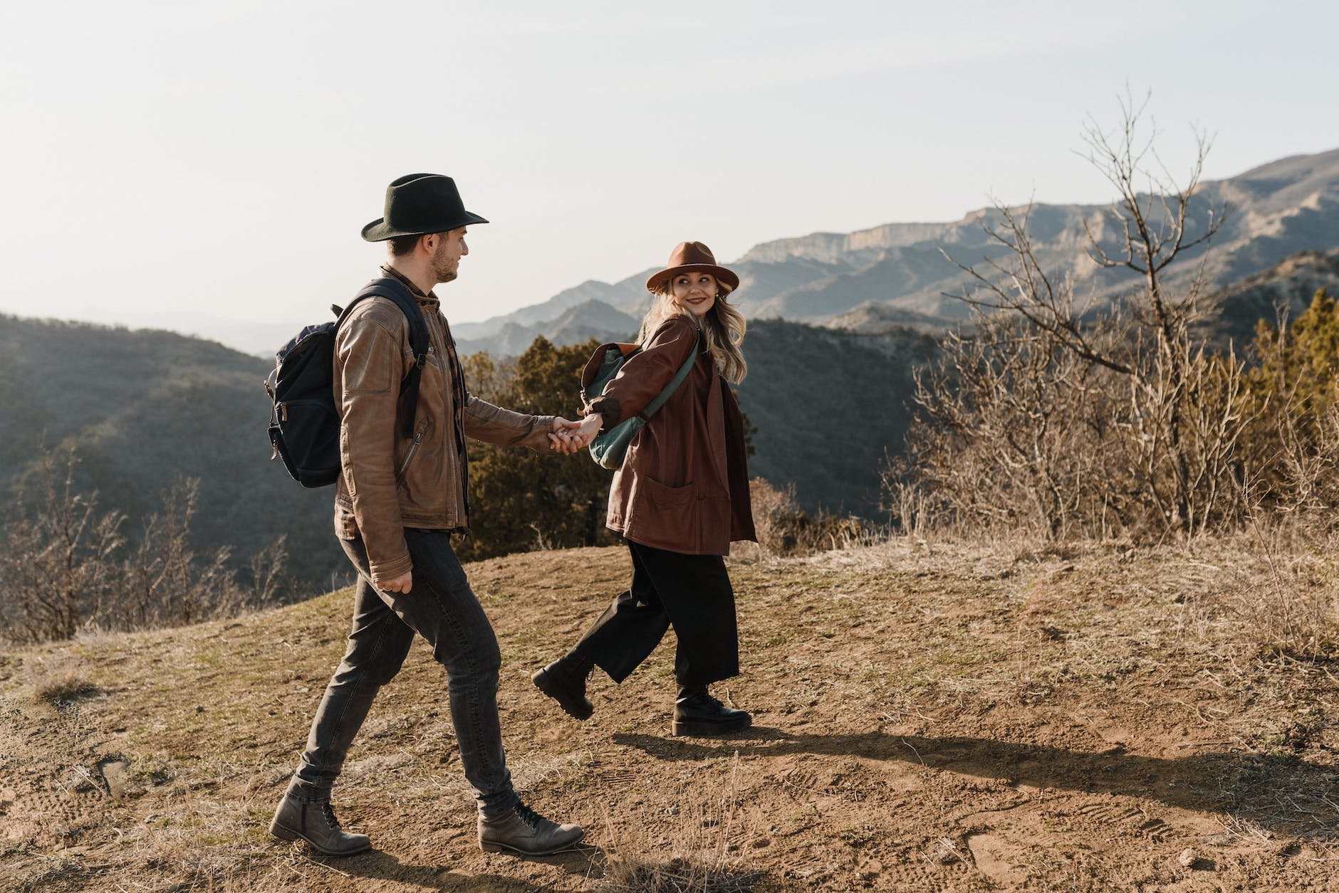 A couple holding hands on a hike