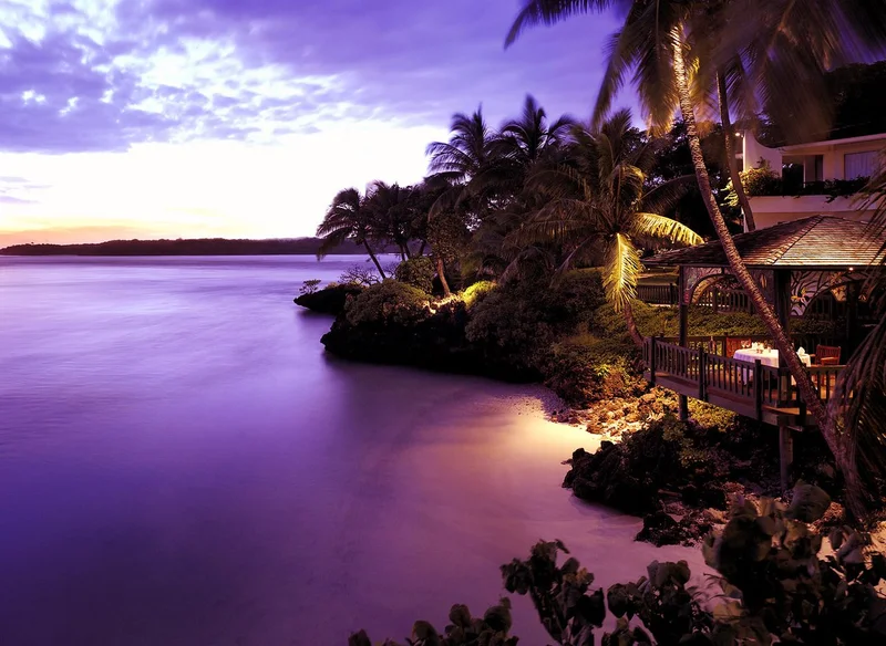 Tropical paradise sunset with palm trees and luxury accommodations
