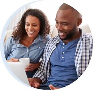 couple on a couch looking at a laptop
