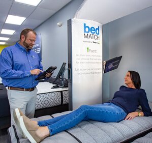 Salesperson with Customer on bedMatch mattress