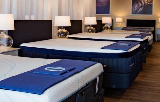 Sleep Outfitters showroom image with multiple mattresses