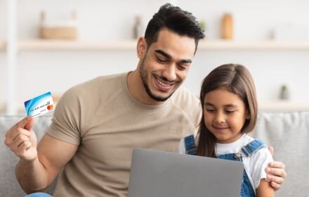 Father and daughter with rewards card