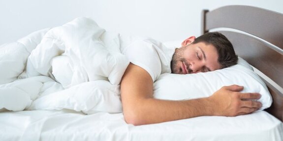 man sleeping on bed