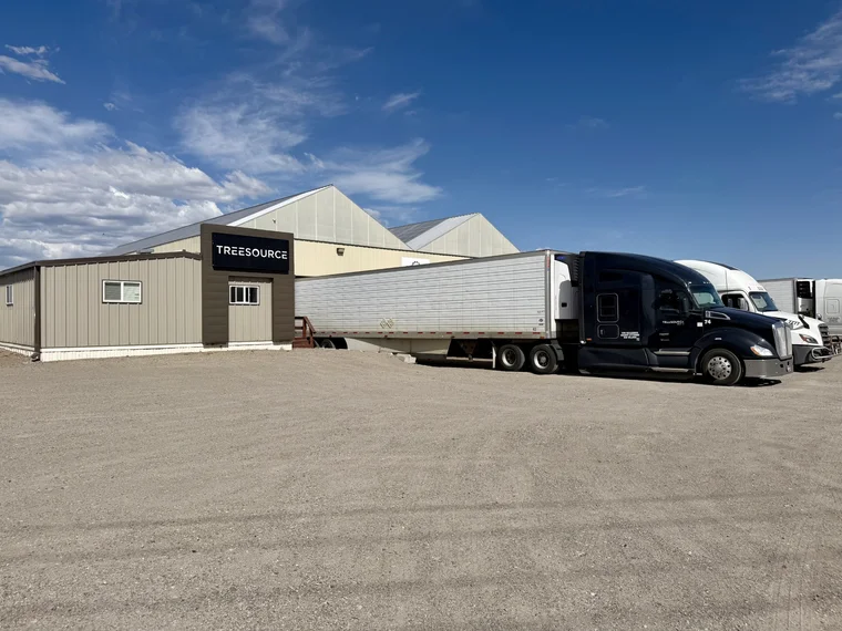 Tree Source branded warehouse with reefer trucks loading at the shipping dock in Rupert, Idaho