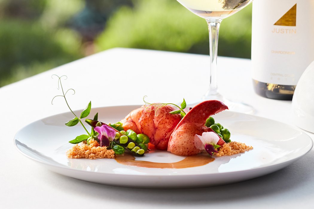 Plump, pink, poached lobster with green peas and golden sauce. 