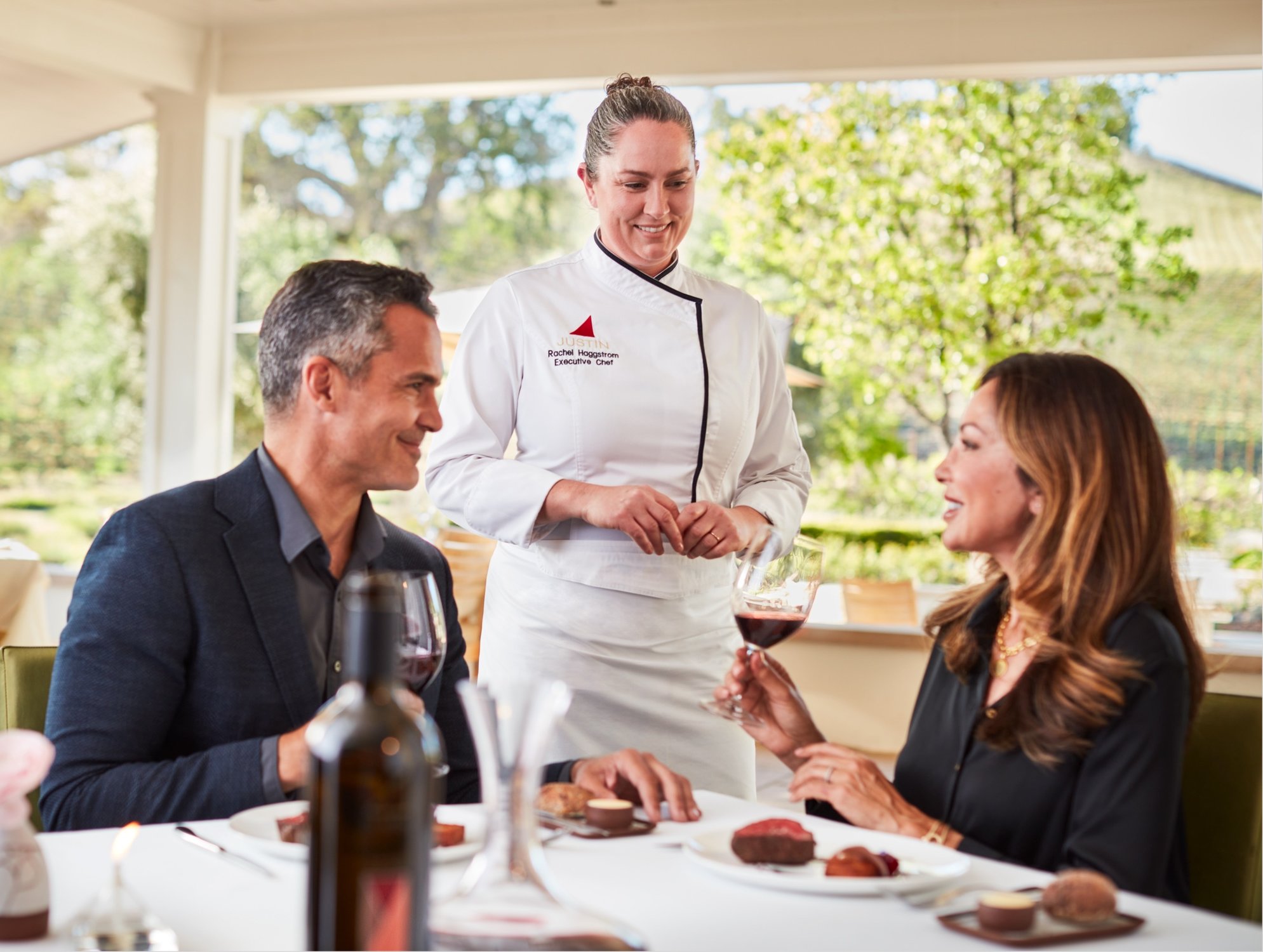 Executive Chef Rachel Haggstrom visits the table of a couple at the Restaurant