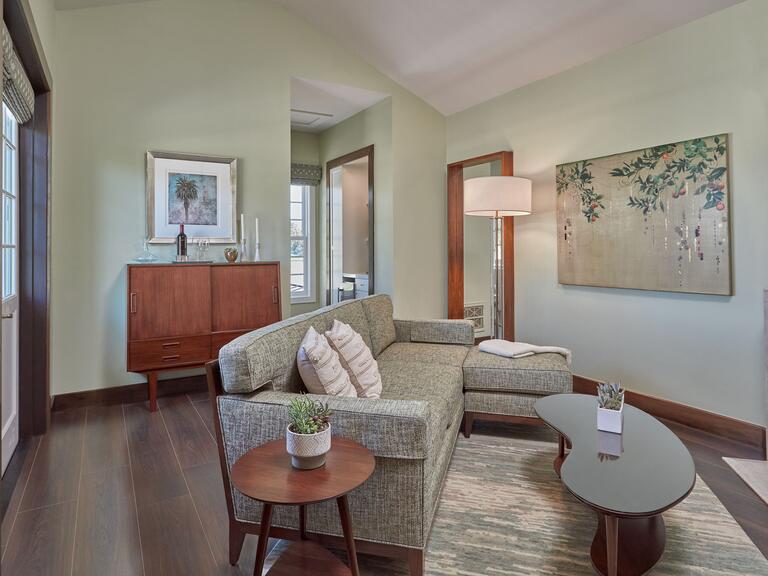 Shared living space with contemporary gray couch with bean shaped coffee table. 