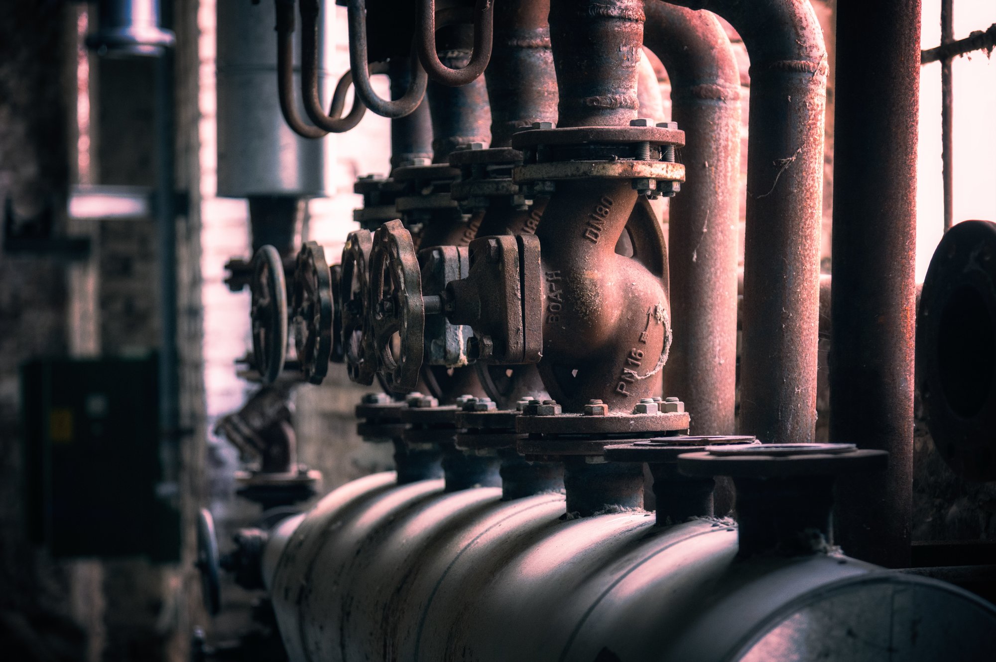 A row of reddish pipes and handles