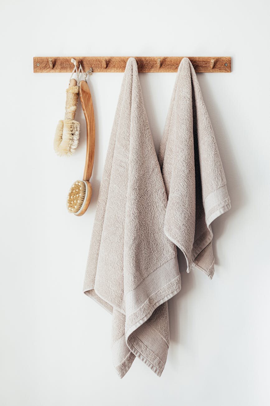 A childs hands and an adults hands folding socks from a pile of laundry