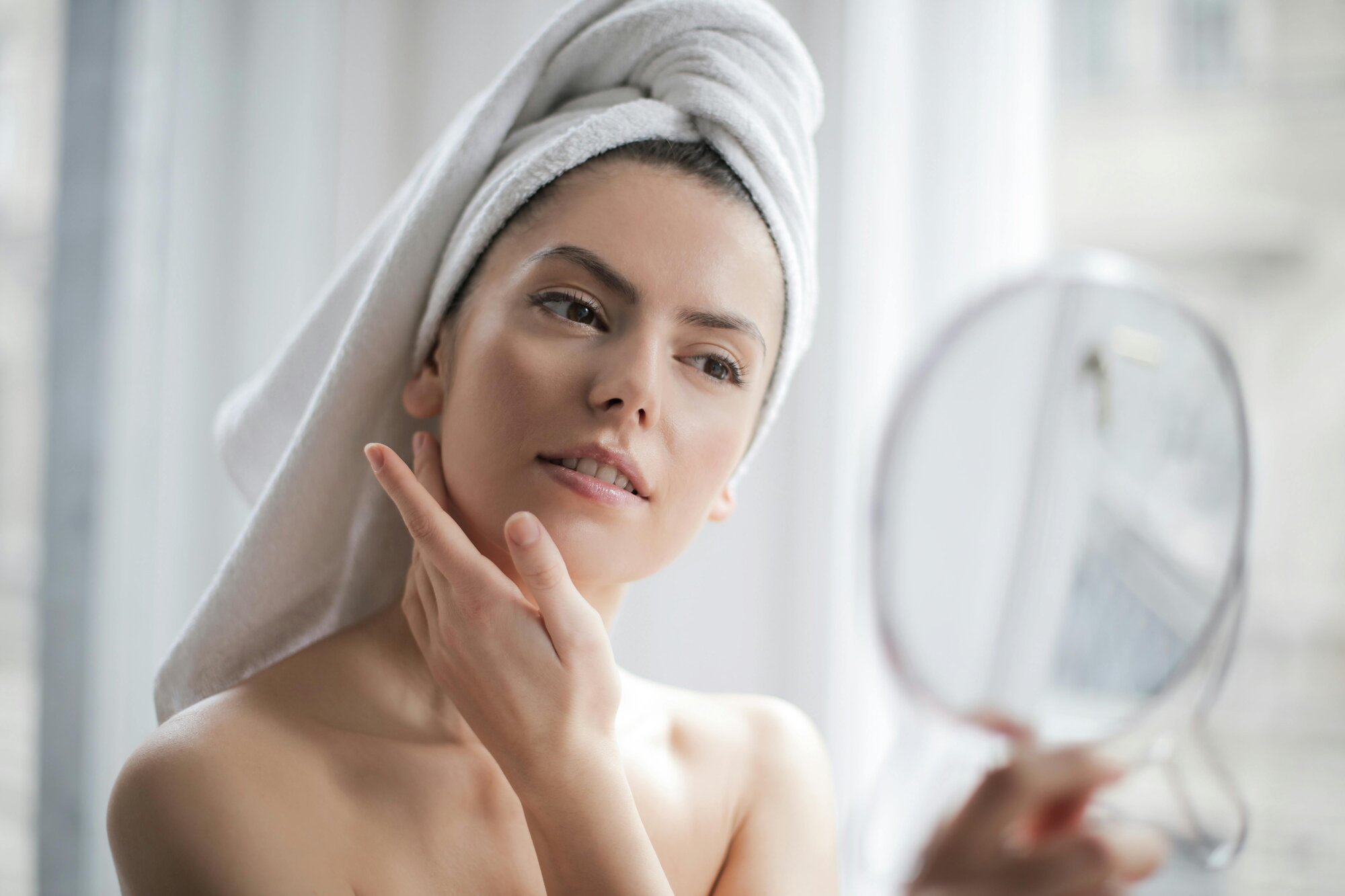 A person applying a cream to their face