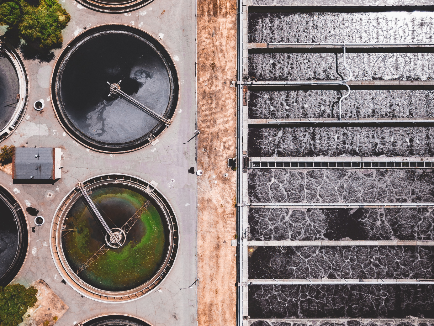 Birds eye view of a water treatment plant with a pool and tanks