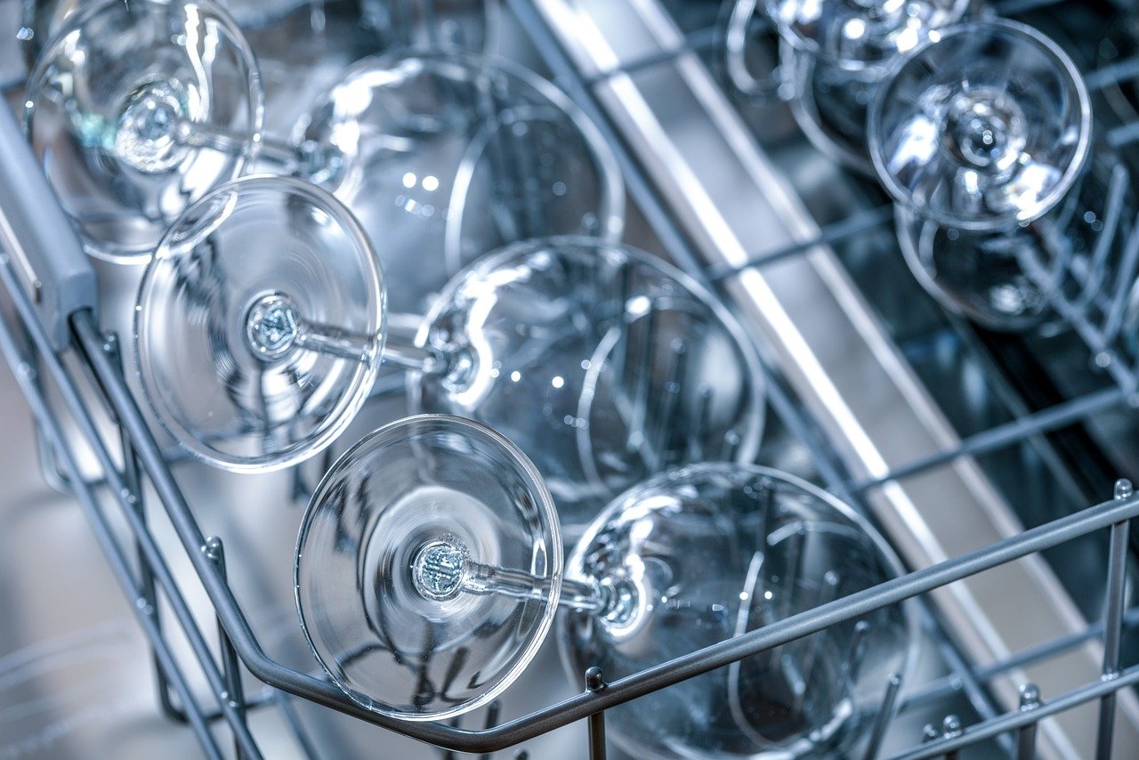 Rack of clean glasses in a dishwasher. 