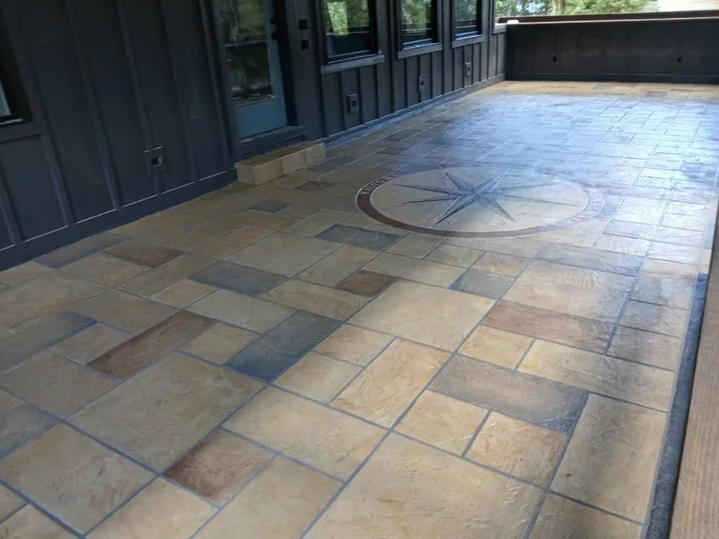 Multi-tone stamped concrete pool deck with a compass medallion