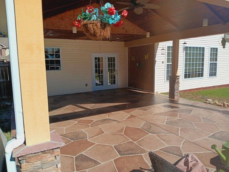 Warm flagstone concrete patio under a covered outdoor living area