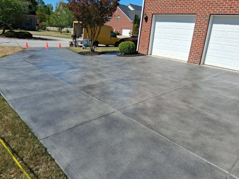 Gray decorative concrete driveway with a saw-cut grid