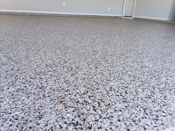 White and charcoal epoxy flake floor in a finished garage