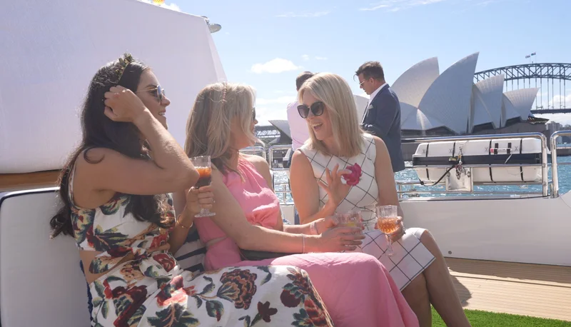 Guests celebrating Melbourne Cup on a yacht with Sydney Opera House backdrop