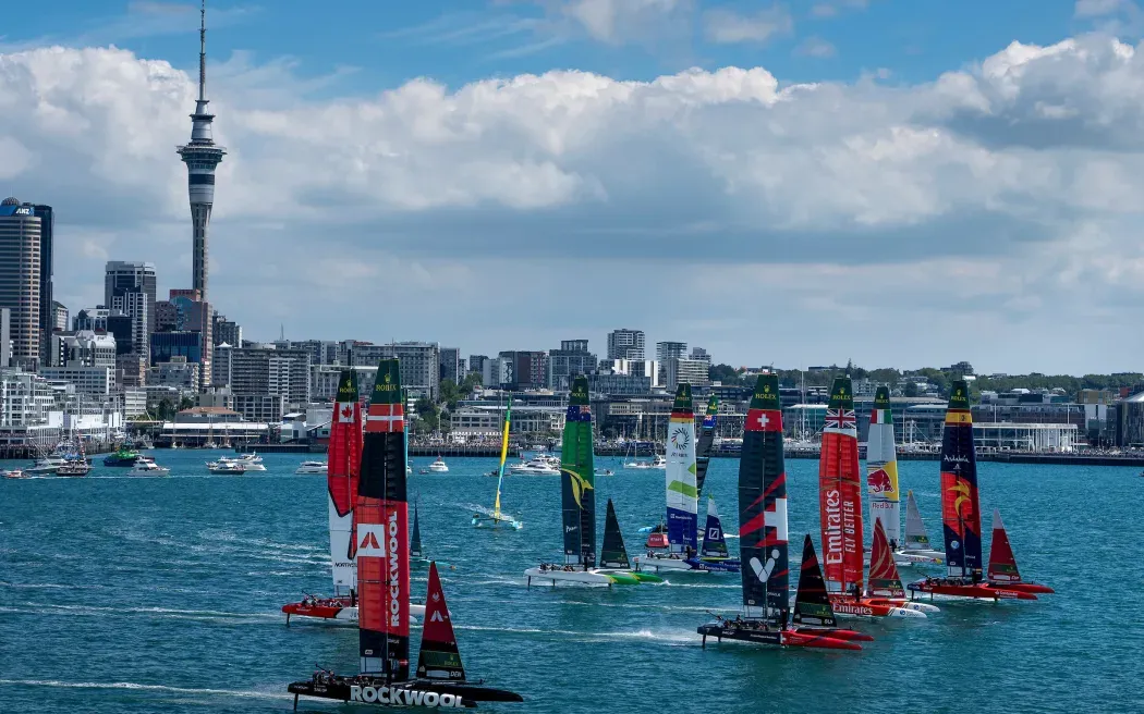 SailGP boats foiling on Waitematā Harbour with Auckland skyline