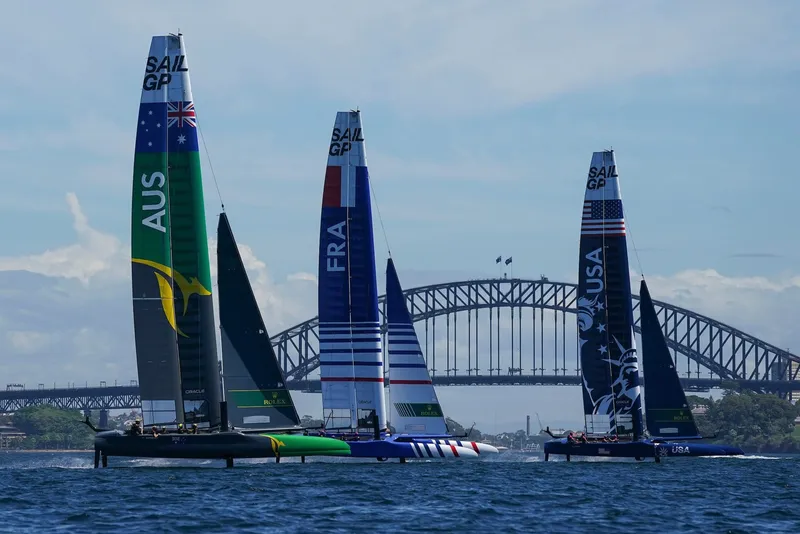 Race boats on Sydney Harbour in front of the Opera House and the Bridge