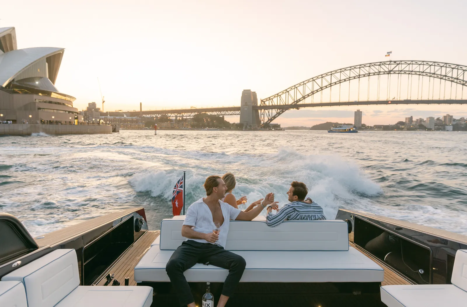 Friends jumping off a day boat in clear water