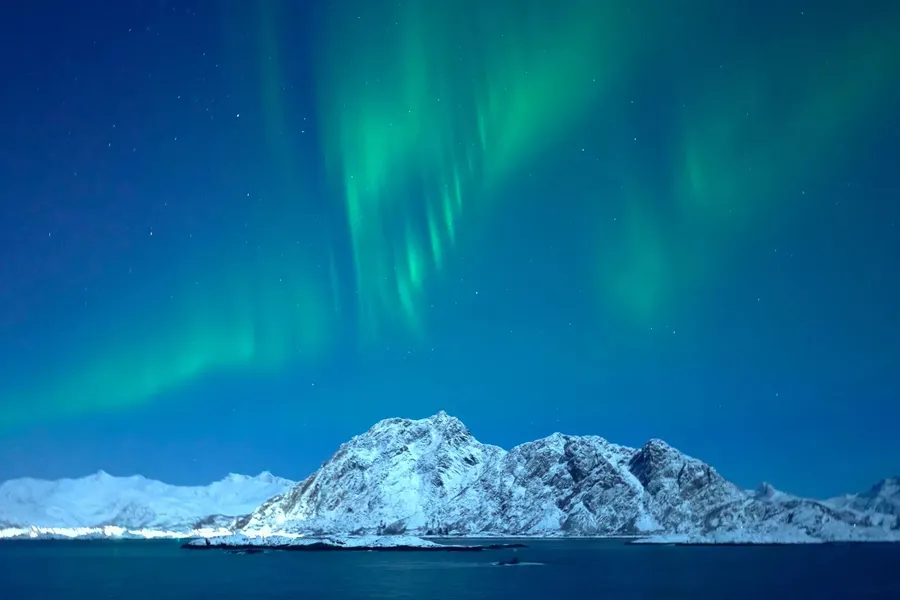 A Norwegian fjord with snow on the peaks