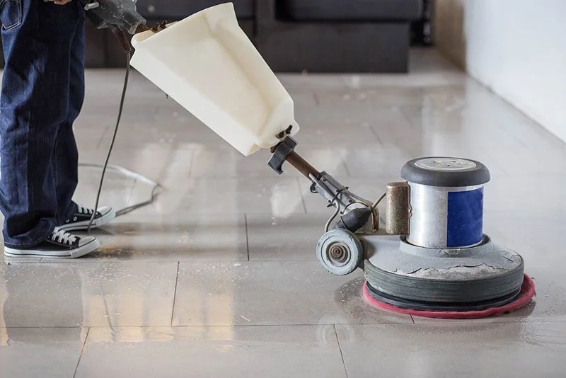 Technician restoring a surface with pressure washing equipment