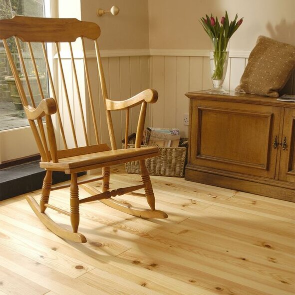 Installed maritime pine floorboards in a living room interior with natural light