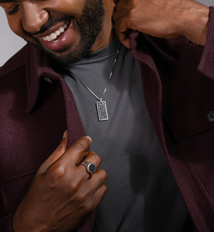 Man wearing a dog-tag pendant necklace