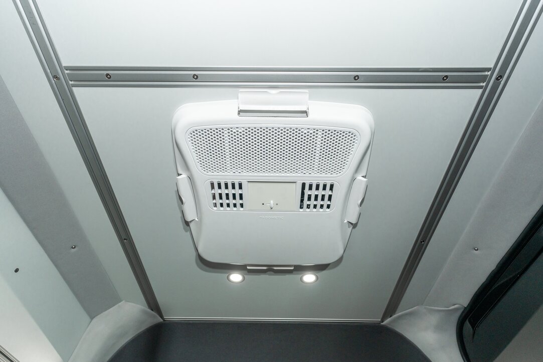 The Dometic Penguin II internal distribution box is integrated into the camper van ceiling. The air controls and vents are highlighted.