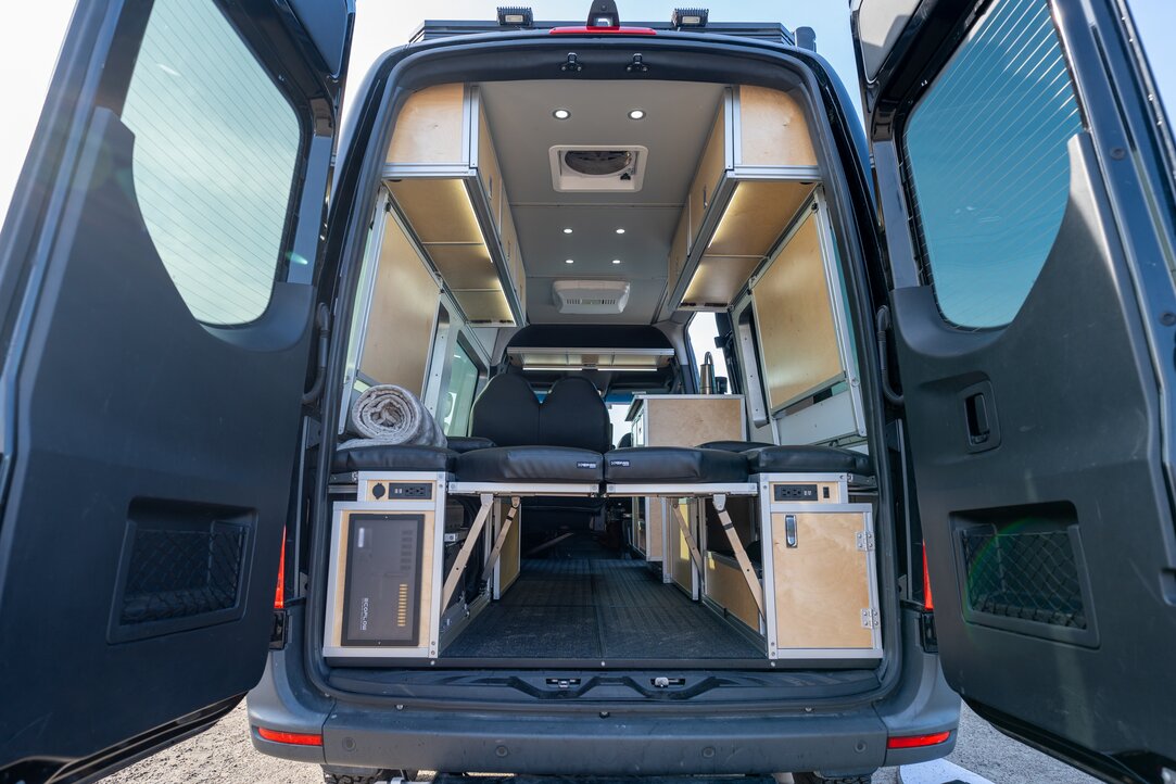 The entire camper van conversion kit is shown installed through the rear doors of the Sprinter 144 4x4. 