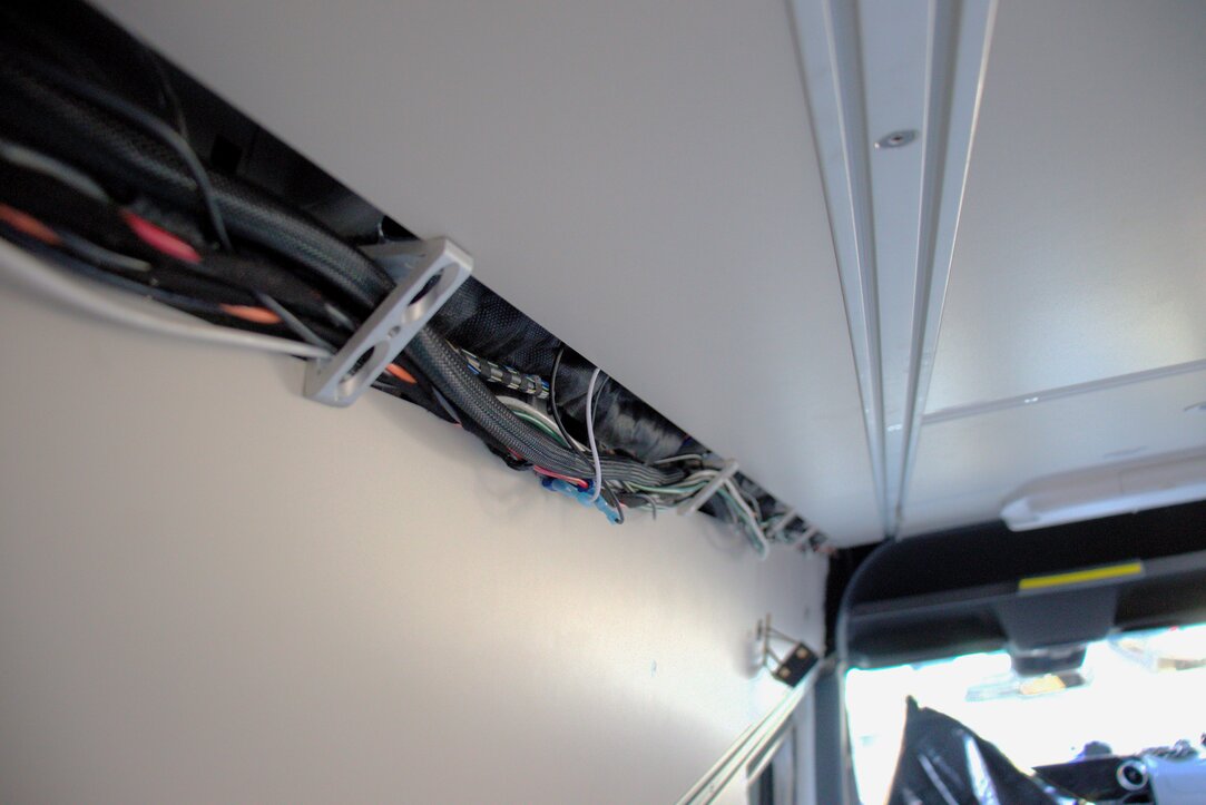 Van conversion electrical wiring harness for plug and play power to off-grid power system EcoFlow Power Kit. The Photo shows the wiring harness running along the driver's wall of the Sprinter Van.