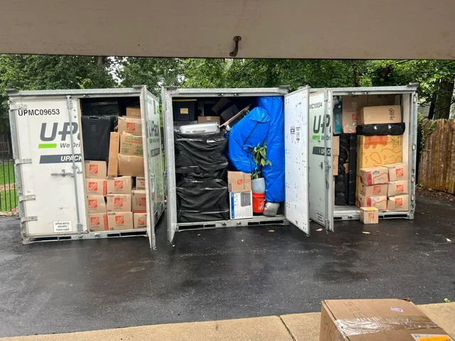 Storage containers loaded with boxes and wrapped furnishings
