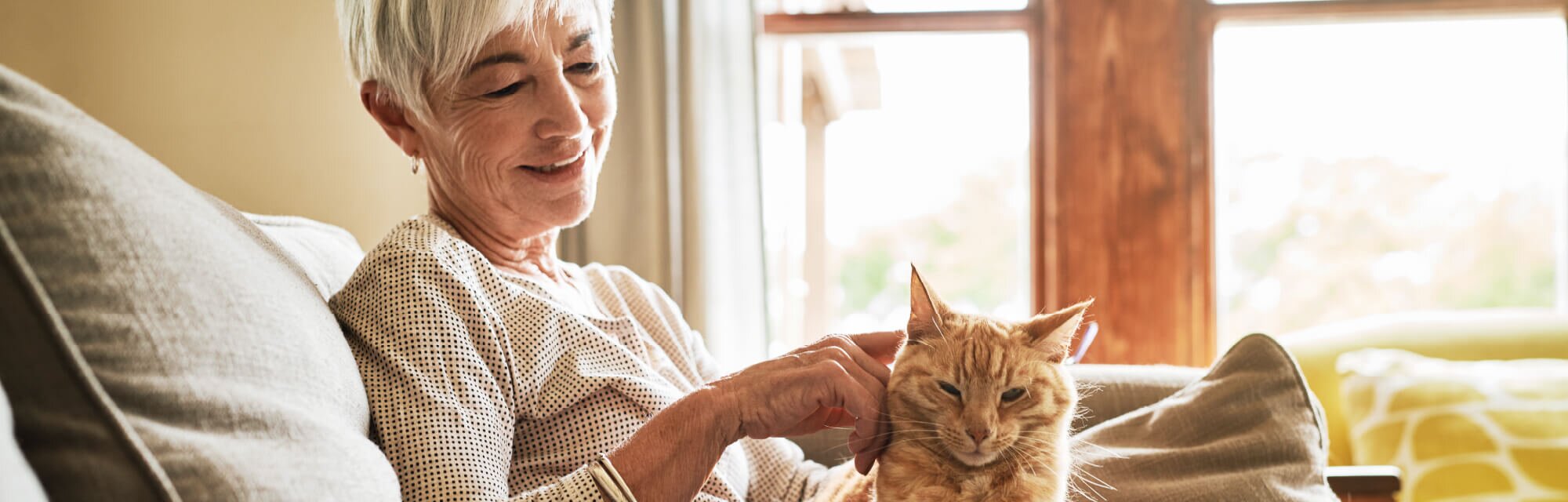 A homeowner sitting comfortably in their well-furnished living space, enjoying the benefits of aging in place.