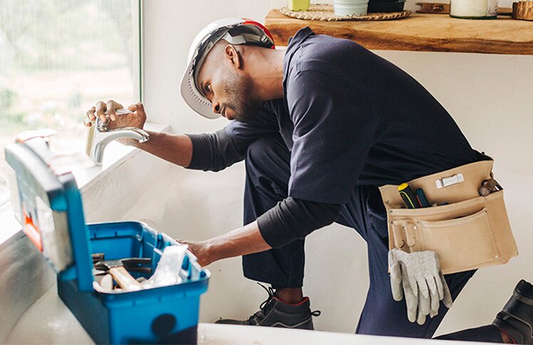 Plumber is installing a faucet
