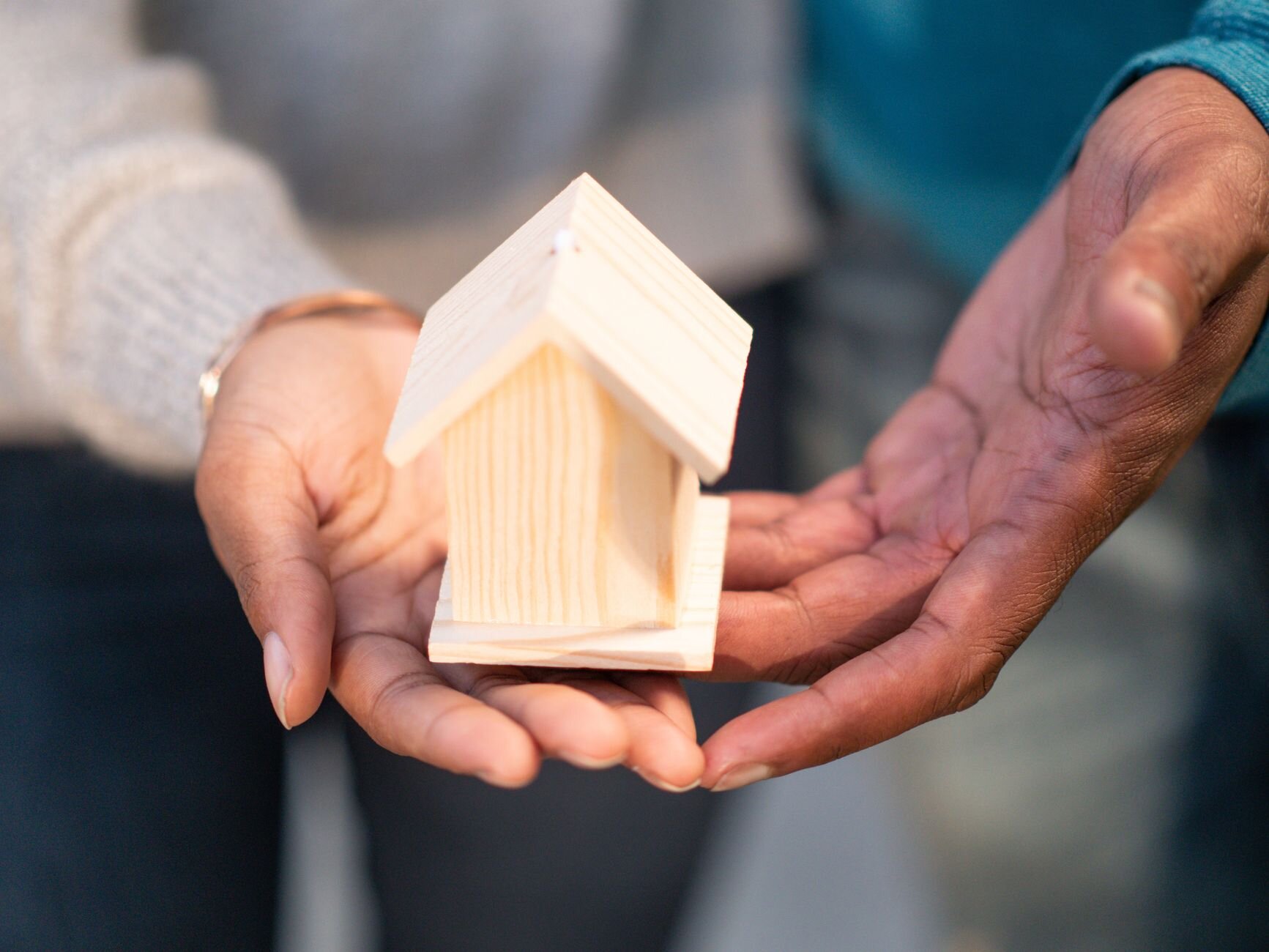 Couple holding a miniature house