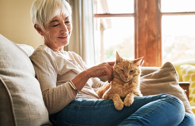 A homeowner sitting comfortably in their well-furnished living space, enjoying the benefits of aging in place.