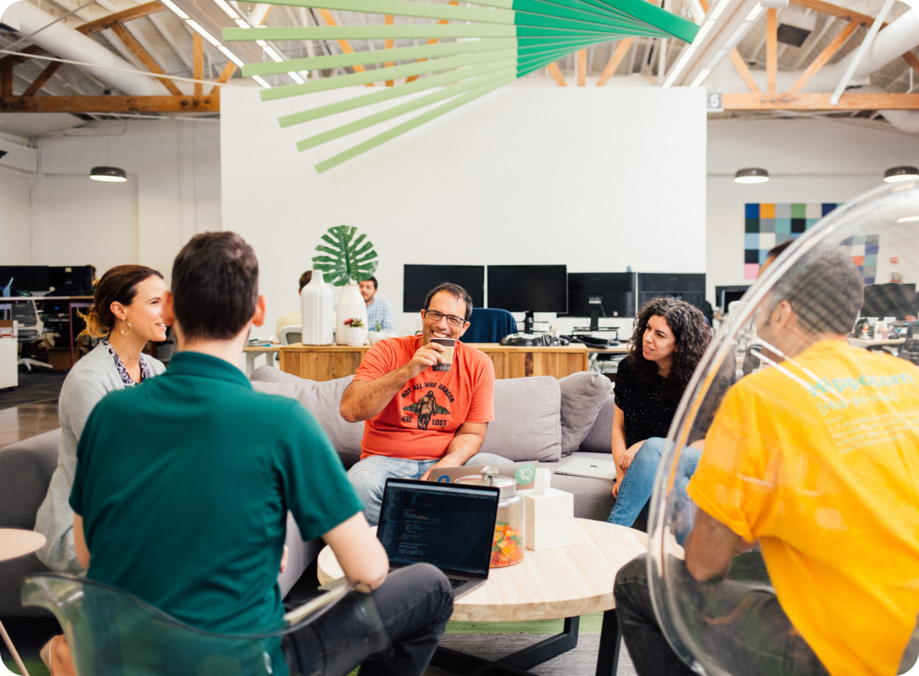 A group of Hippo employees gathered around a table in a collaborative meeting.