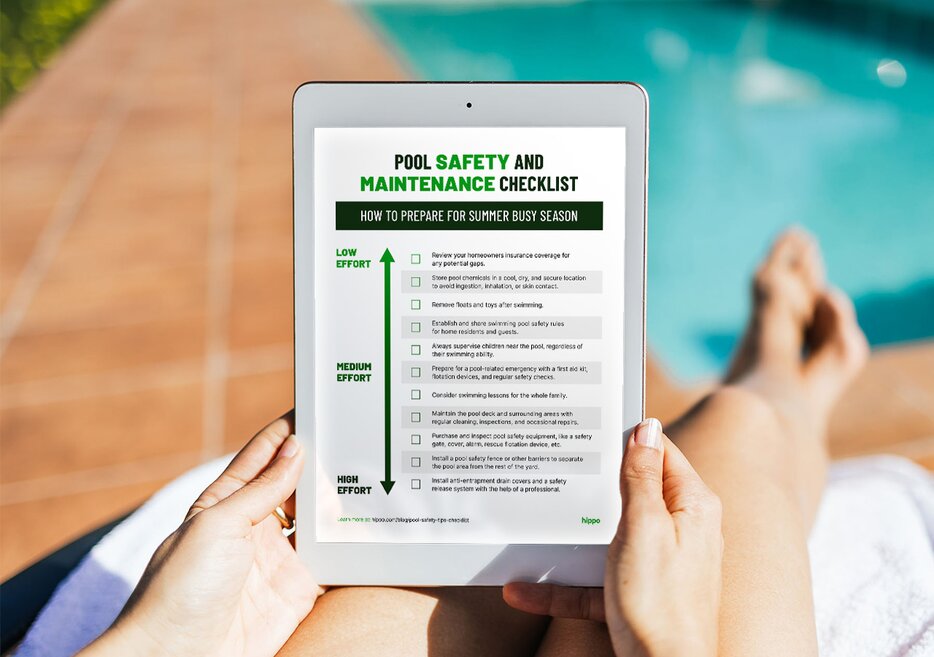 A homeowner reviews their pool safety tips checklist while lounging by the pool. 