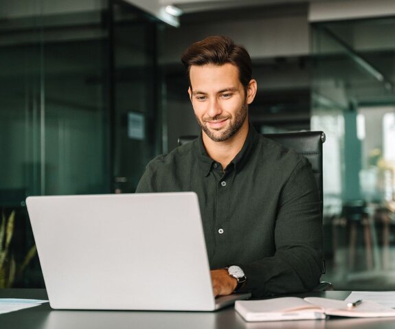 A person working at a desk with a laptop.